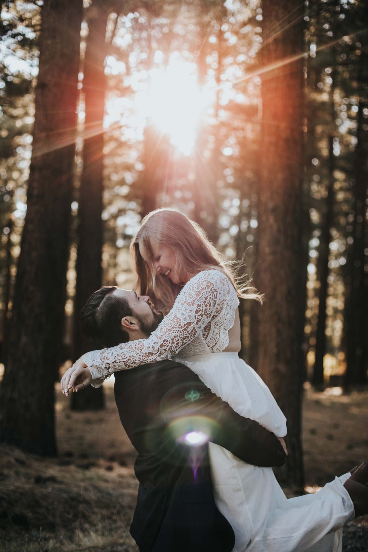 sunnybrook-bride-groom-lift-woods-sun-rays-vertical